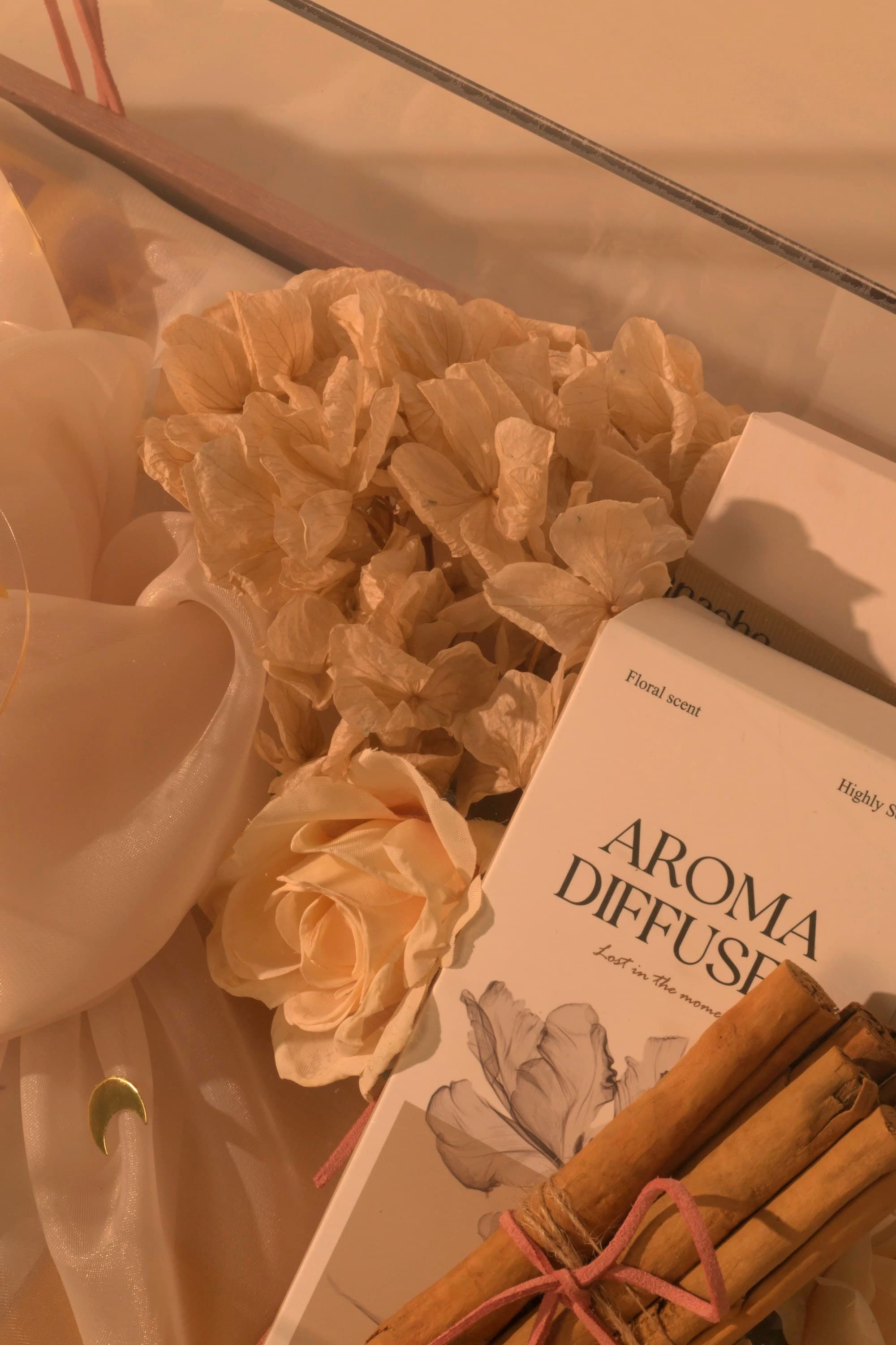 Dried florals and a rose finishing a Bare & Brown gift by hand