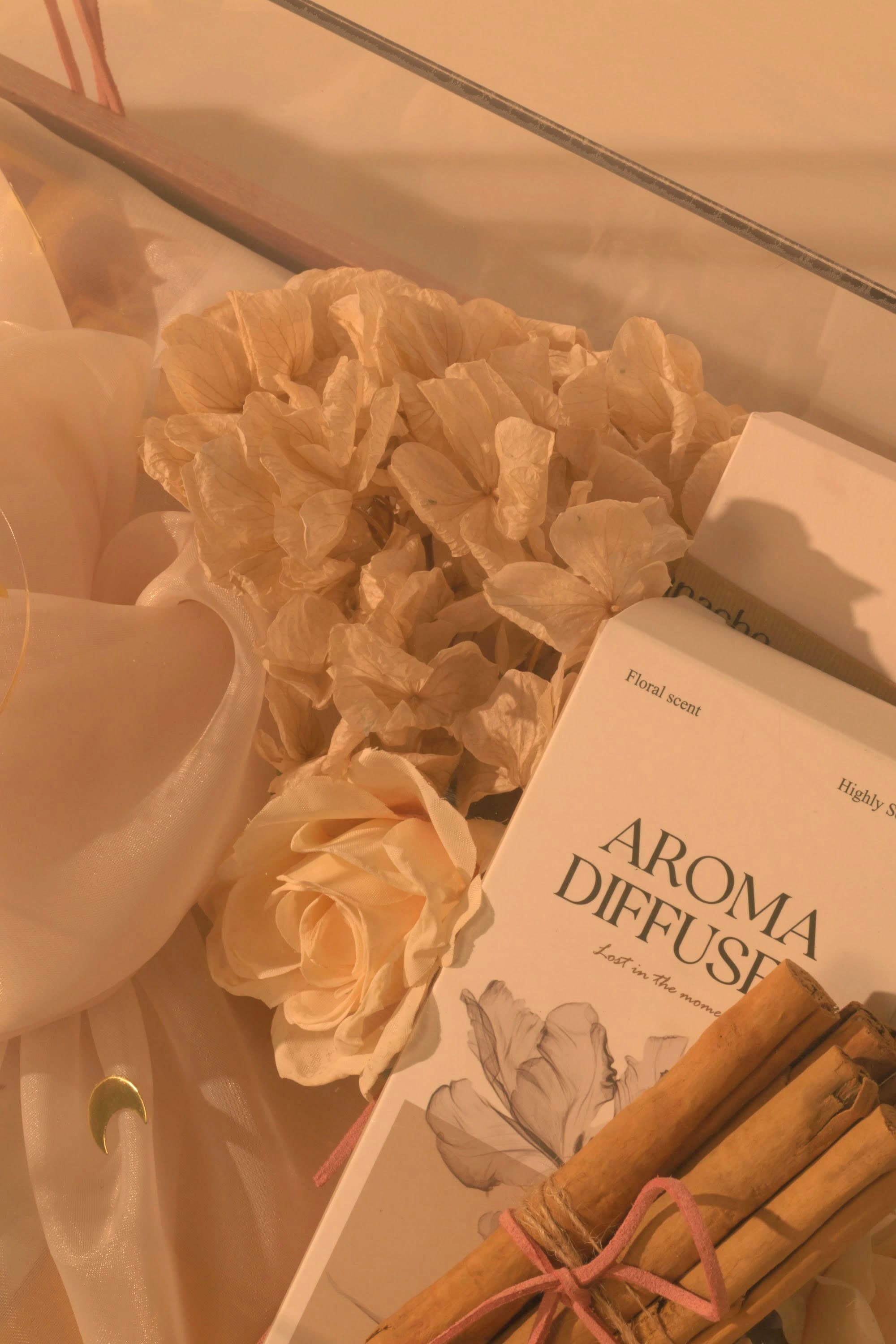 Dried florals and a rose finishing a Bare & Brown gift by hand