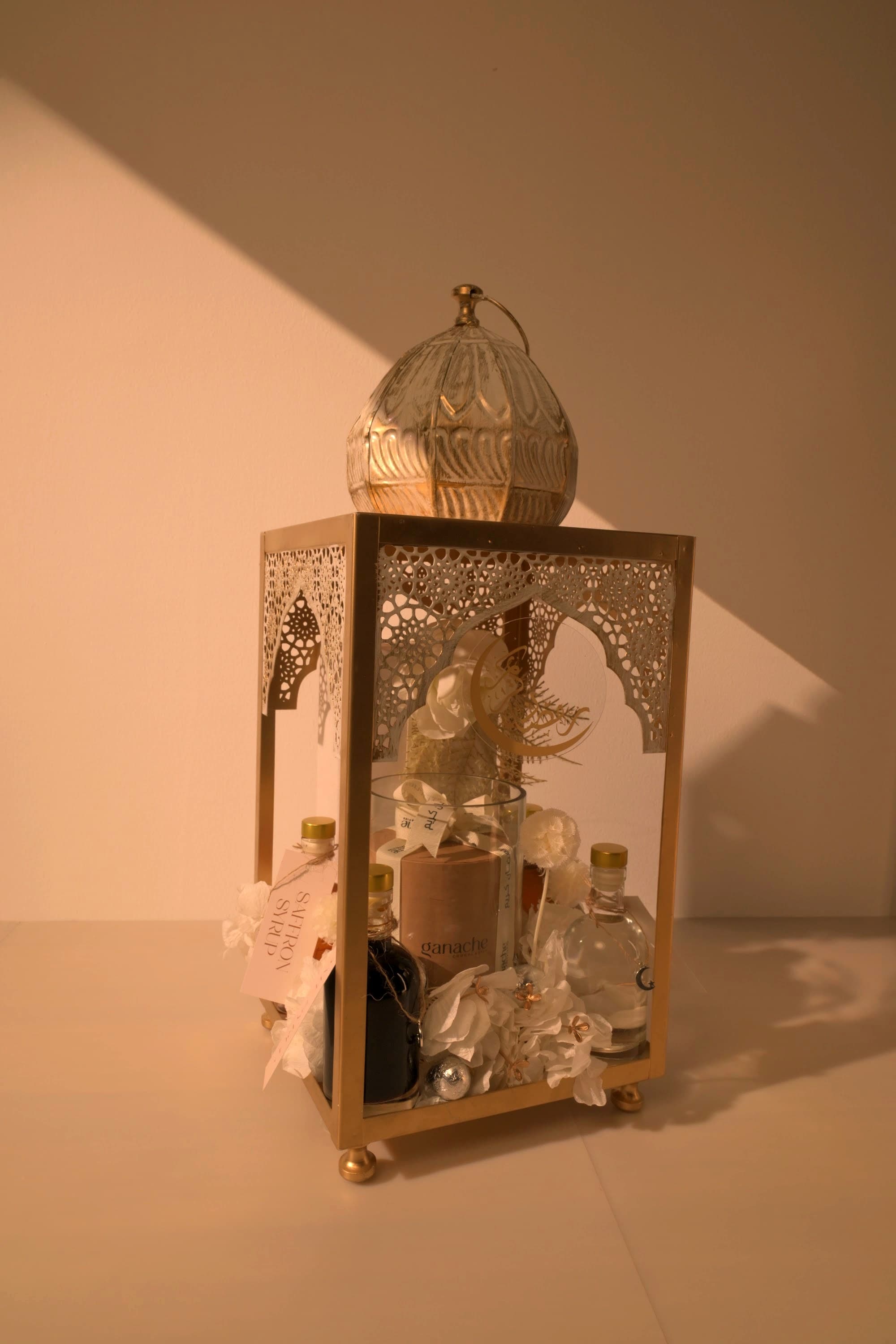 A gold lantern gift arrangement by Bare & Brown, delivered across Dubai
