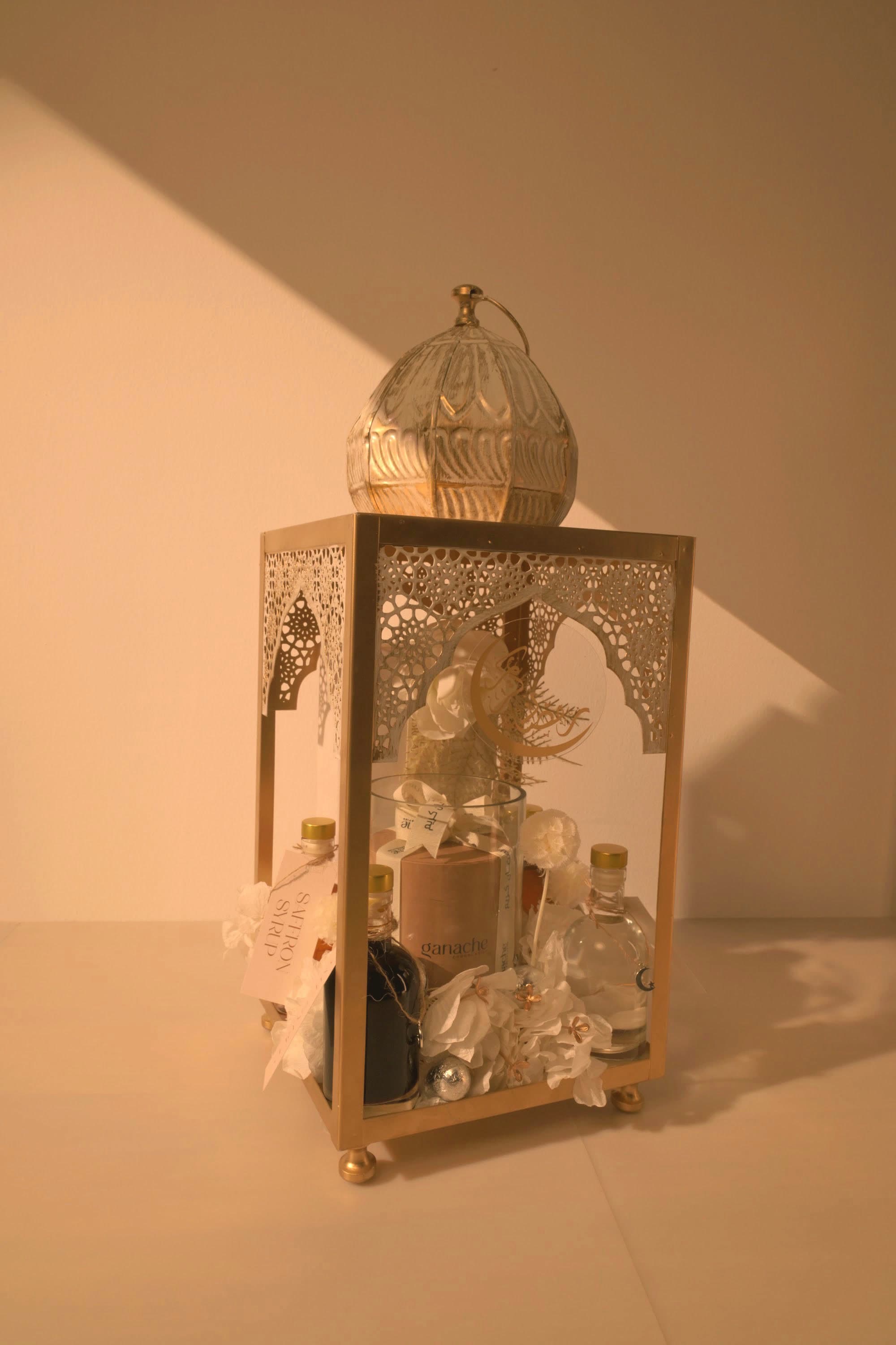 A gold lantern gift arrangement by Bare & Brown, delivered across Dubai